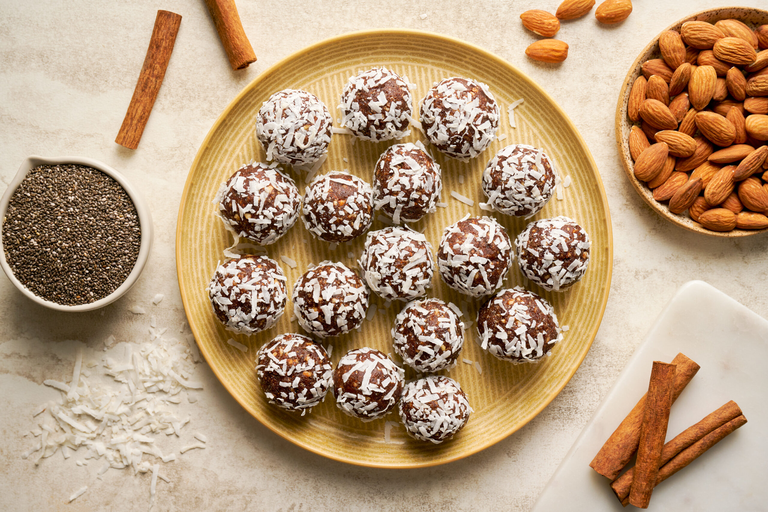 chocolate cinnamon energy bites with almonds, cinnamon sticks, and chia